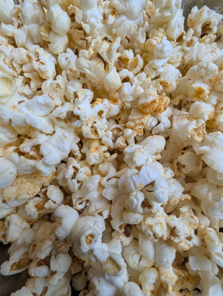 Extreme close-up of homemade sweet and salty popcorn with paprika seasoning visible on the kernels